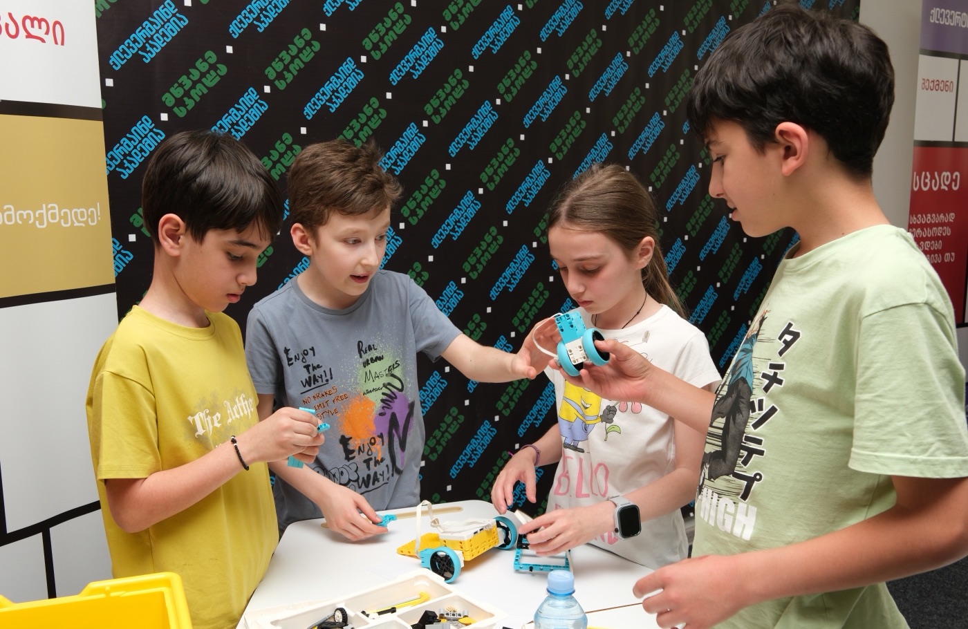 Students showing the LEGO robots they built